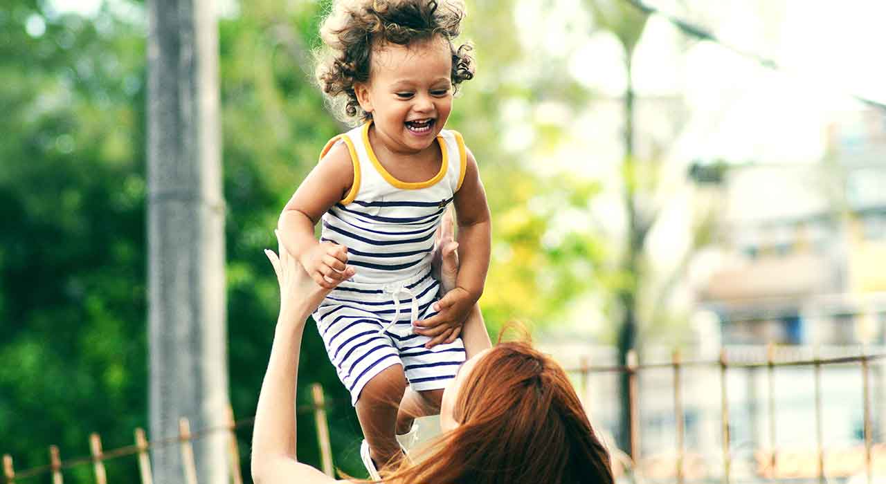 Woman grabbing smilling kid represents new prevention, diagnosis and treatment methods