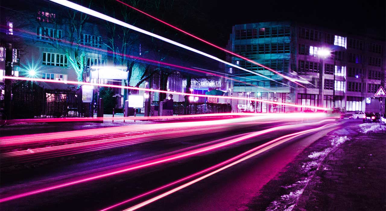 Header, Purple city street timelapse represents our hybrid cloud solution that provides a ready-to-use self-service catalog and fully automated service lifecycle management